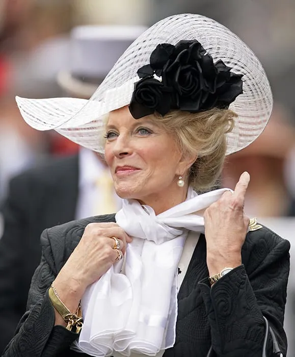 Princess Michael of Kent with hair bun and white cap,