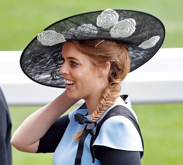 Princess Beatrice with a black hat and braid hairstyle