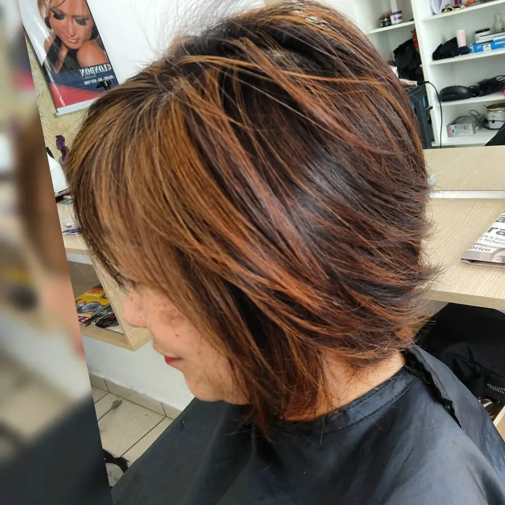 A women is showing side view of her cooper shimmer blonde hair color with side pose A women is showing side view of her cooper shimmer blonde hair color with side pose - short hair color