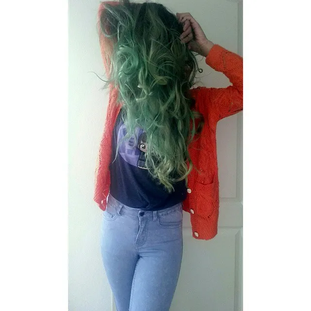 A girl in light blue jeans, blue t-shirt with red front open sweater showing the side view of her green tea hair color A girl in light blue jeans, blue t-shirt with red front open sweater showing the side view of her green tea hair color - green hair color