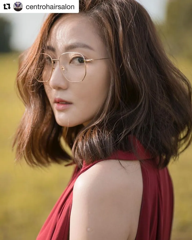 A girl in maroon cut sleeves top and spectacles showing her Havana Brown Blonde Hair color with side pose  A girl in maroon cut sleeves top and spectacles showing her Havana Brown Blonde Hair color with side pose - hair care