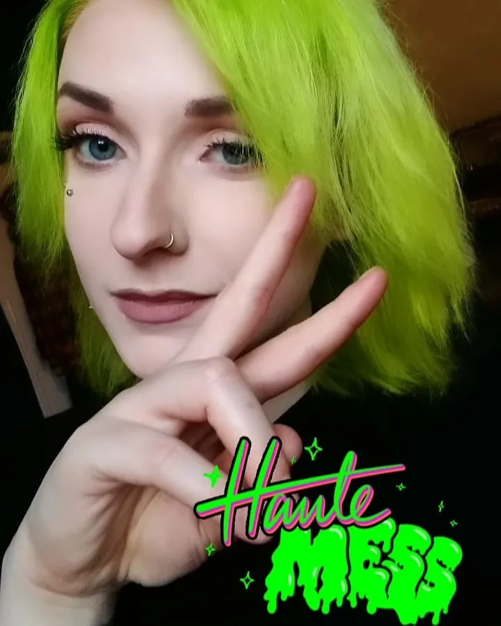 A girl is posing for camera and showing her neon green hair color A girl is posing for camera and showing her neon green hair color - green hair color ideas