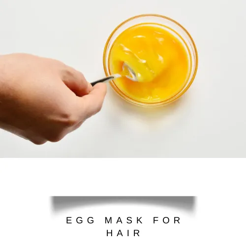 whisking egg yolks with aloe vera gel and olive oil in a bowl - hair fall control mask