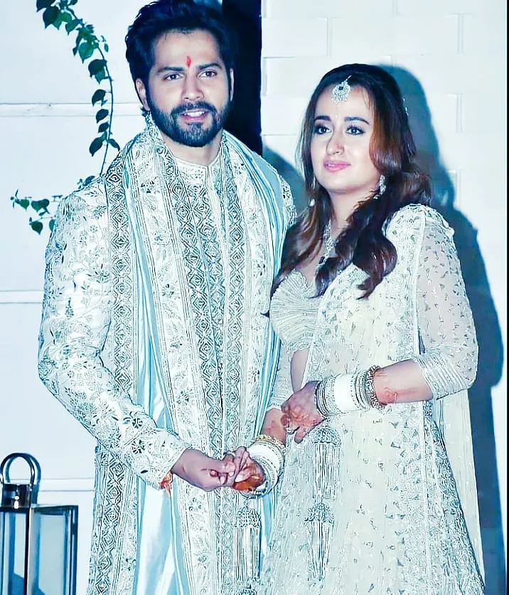 Varun Dhawan and Natasha Dalal posing for camera in their wedding outfit - celebrities who got married in 2021
