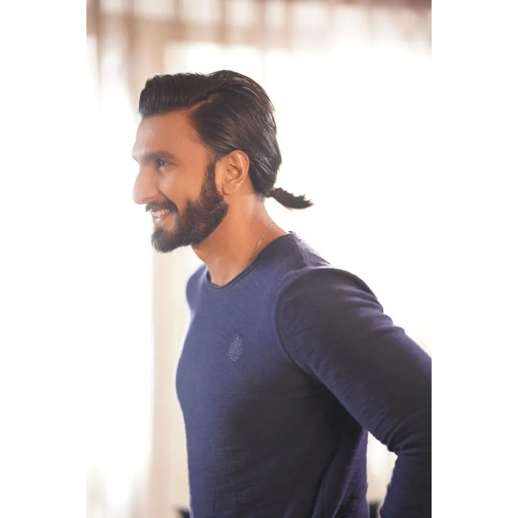 Smiling Ranveer Singh in Blue t-shirt and Mini Ponytail - Ranveer Singh Hairstyle 2021 