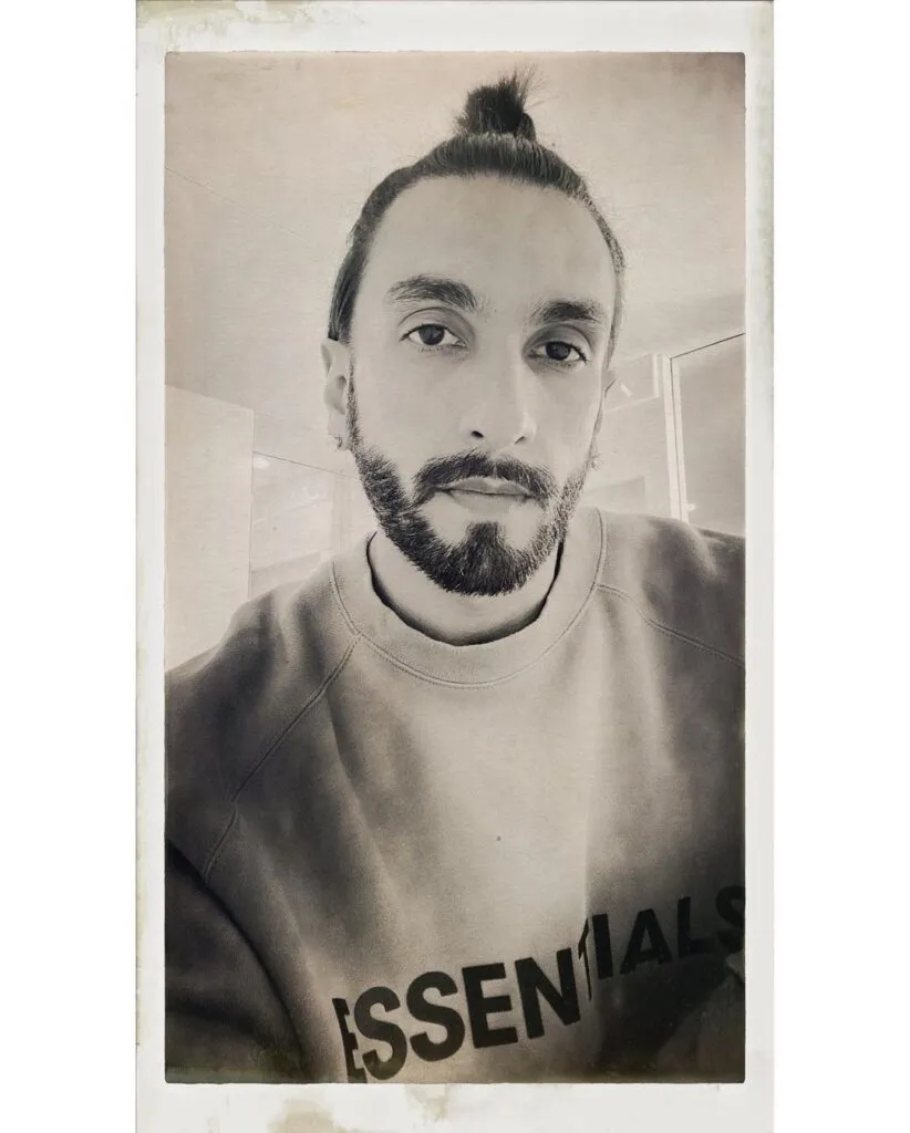 Ranveer in a black & white pic showing his top knot - Ranveer Singh Long Hairstyles