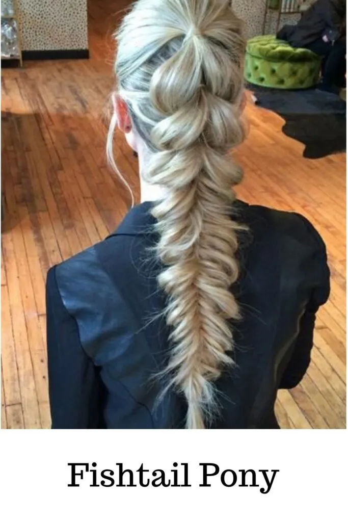 A lady is blue dress and ash blonde hair color showing her Fishtail Pony - ponytail hairstyles braids