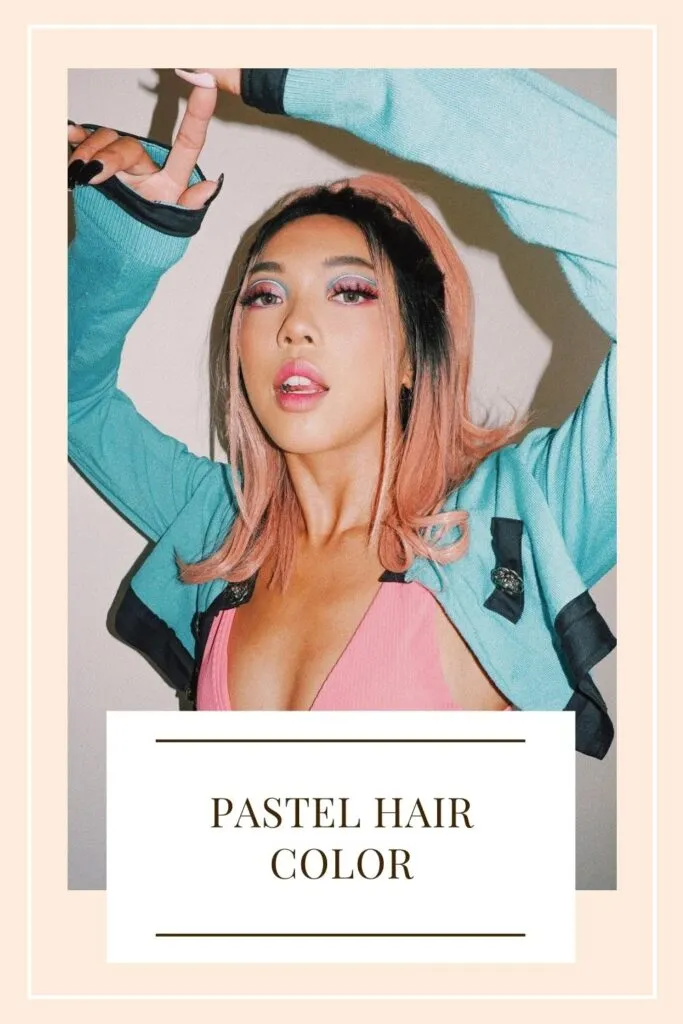 A girl in pink crop top and blue jacket showing her pink pastel color - hair color for women 2021