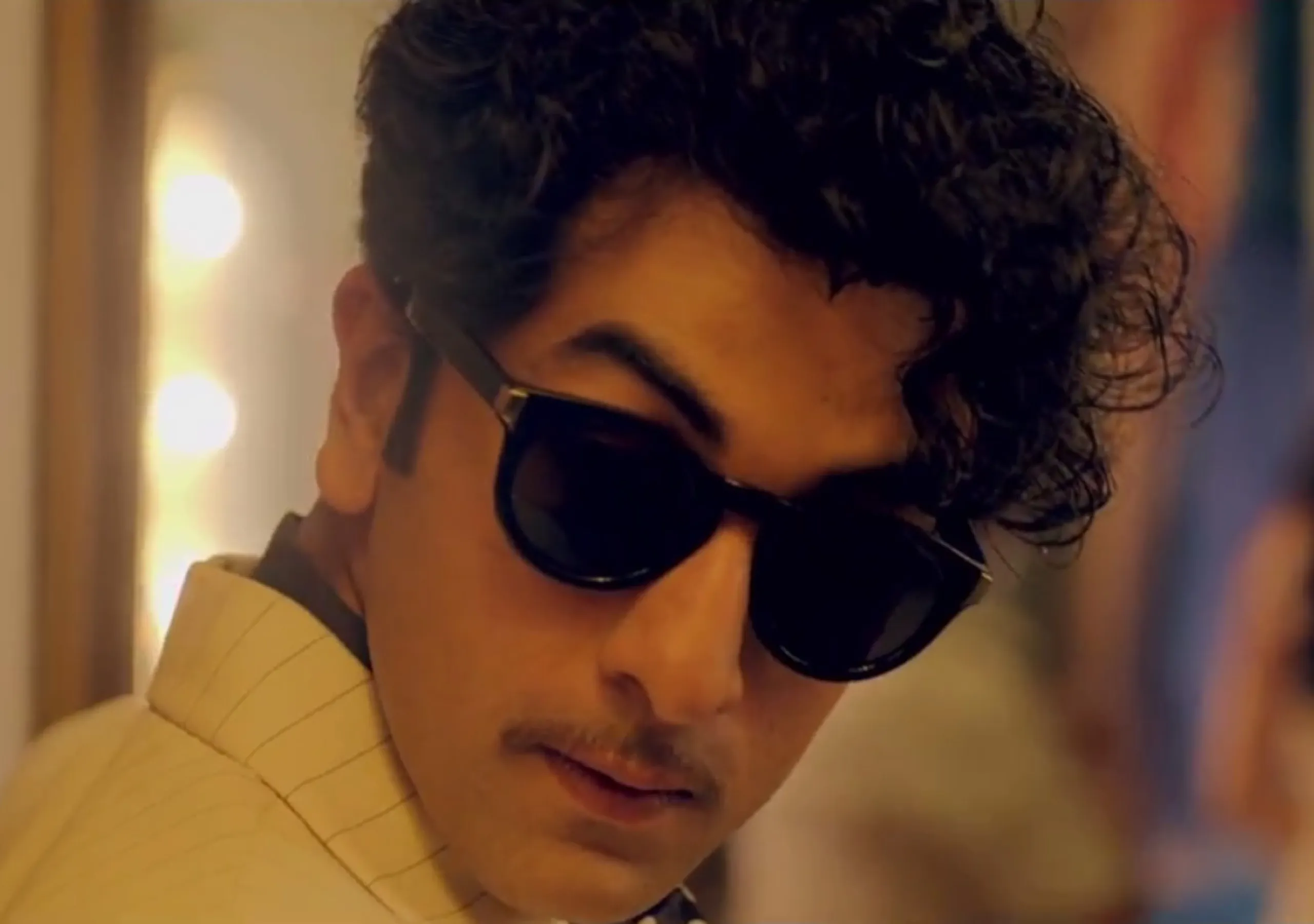 Ranbir in Black Googles and messy curls giving a side pose - Ranbir Kapoor Hairstyles Pic