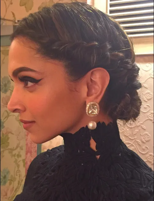 Deepika in all black look with braided bun giving side pose Deepika in all black look with braided bun giving side pose - deepika padukone different hairstyles