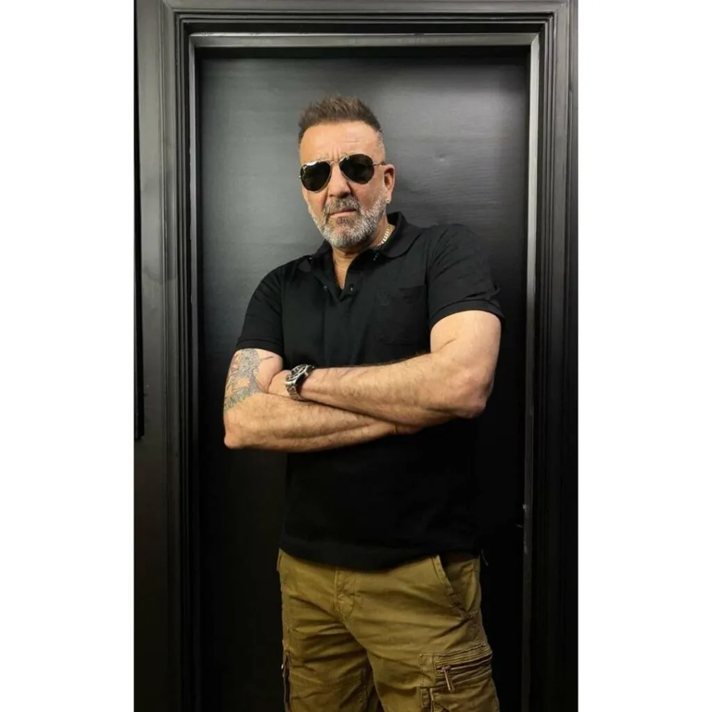 Sanjay Dutt in black t-shirt and goggles posing for camera Sanjay Dutt in black t-shirt and goggles posing for camera - handsome Indian actors