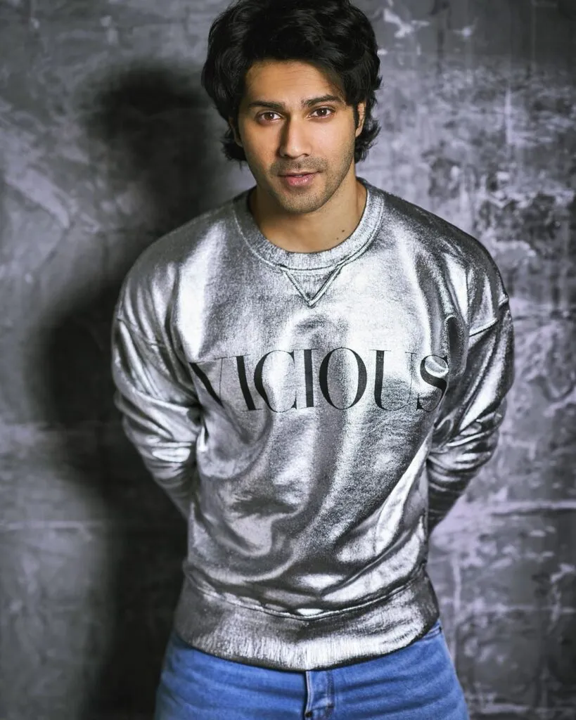 Varun Dhawan in shiny grey t-shirt posing for camera Varun Dhawan in shiny grey t-shirt posing for camera - male actors in India