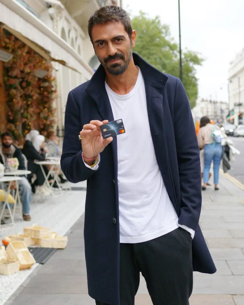Arjun Rampal in black jacket and white t-shirt showing his card Arjun Rampal in black jacket and white t-shirt showing his card - hottest man in India