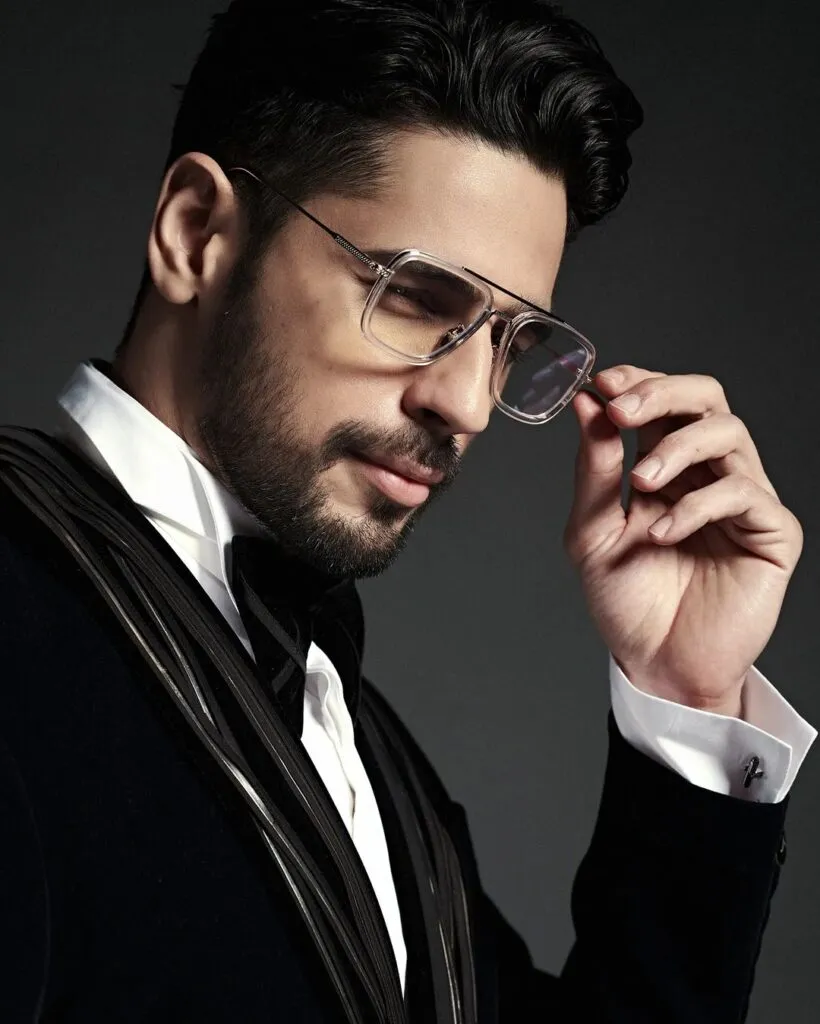 in black coat and white shirt Sidharth Malhotra posing with goggles in black coat and white shirt Sidharth Malhotra posing with goggles - bollywood handsome actors