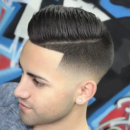 A boy is looking downward and showing his Comb Over + Curved Razor Part hairstyle A boy is looking downward and showing his Comb Over + Curved Razor Part hairstyle - hairstyle for boys