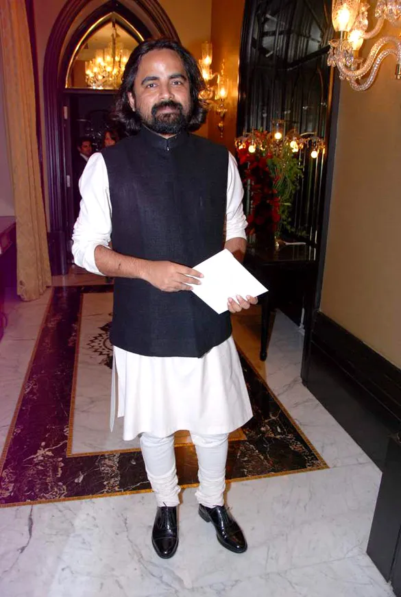 Sabyasachi Mukherjee standing in white kurta pajama with black Nehru jacket Sabyasachi Mukherjee standing in white kurta pajama with black Nehru jacket - gay celebrities India