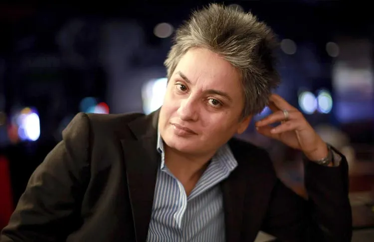 Vasu Primlani sitting in brown coat and blue lining shirt Vasu Primlani sitting in brown coat and blue lining shirt - gay and lesbian celebrities India