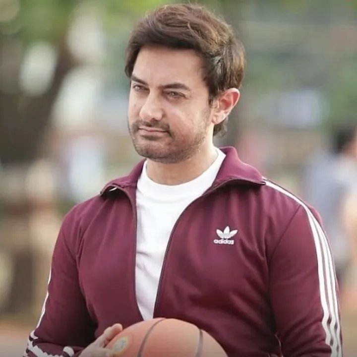 Aamir Khan in purple jacket and white inner posing with a ball Aamir Khan in purple jacket and white inner posing with a ball - Shorts actors of bollywood