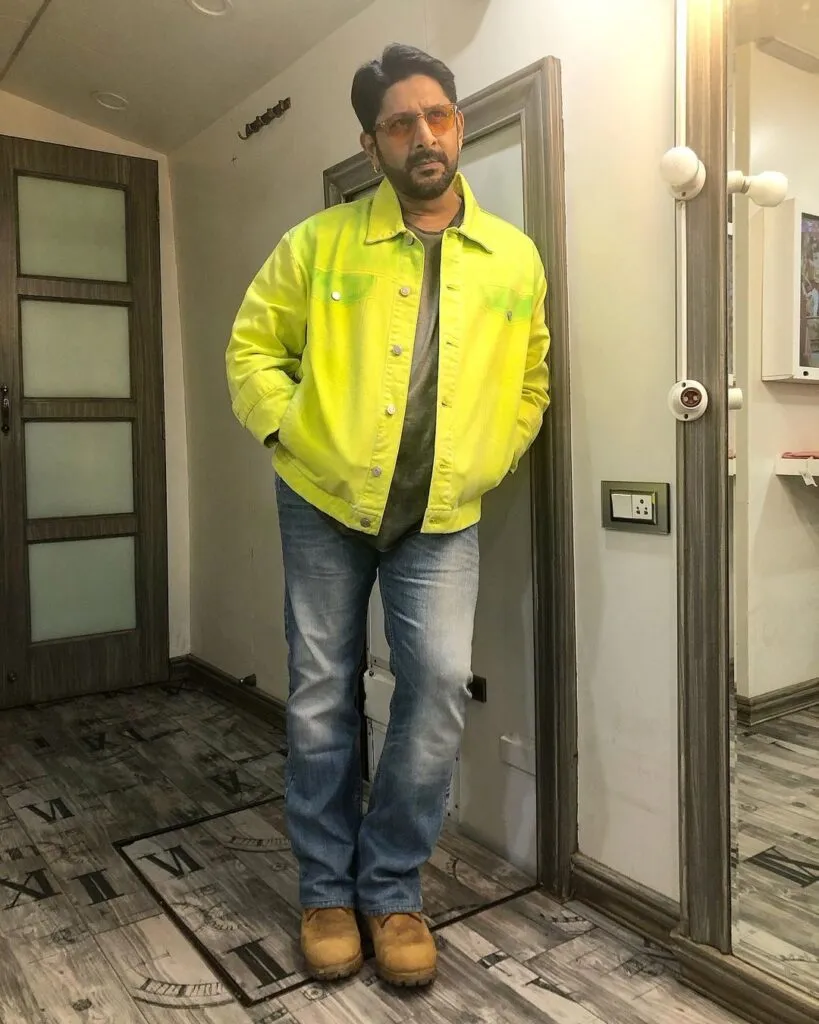 Arshad Warsi in blue jeans and yellow jacket posing for Camera Arshad Warsi in blue jeans and yellow jacket posing for Camera - List of Shirt actors