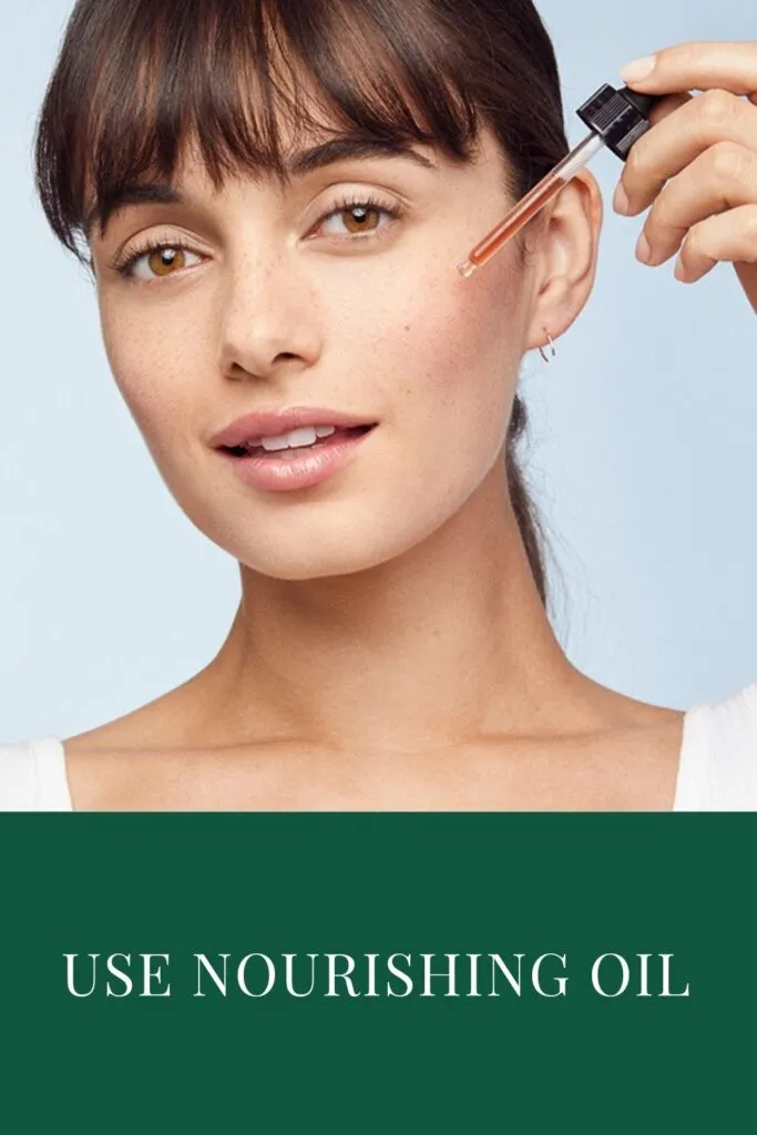 A girl is applying nourishing cream on her cheek A girl is applying nourishing cream on her cheek - best night skin care routine