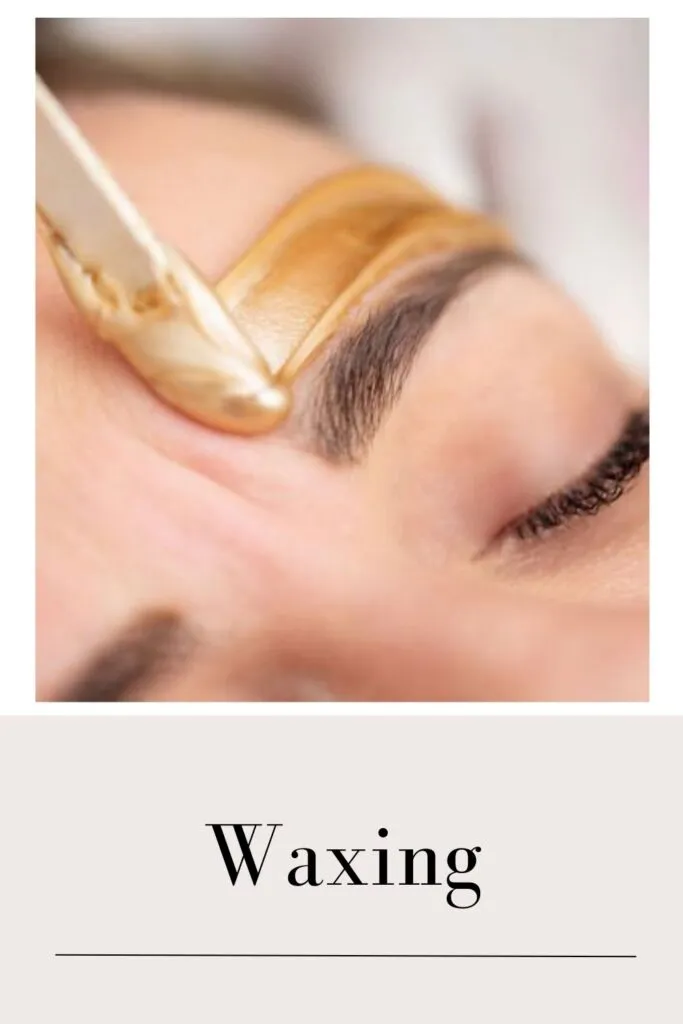 A lady is setting her eyebrows with the help of waxing A lady is setting her eyebrows with the help of waxing - glowing skin