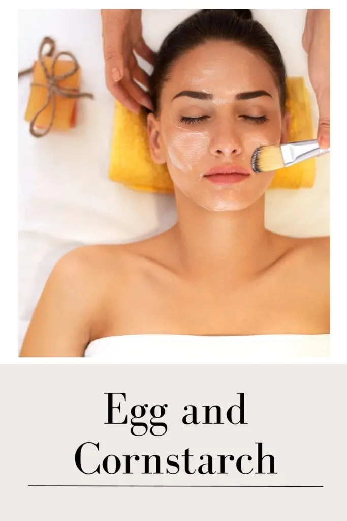 A lady in white tube top applying egg and cornstarch face mask with a brush A lady in white tube top applying egg and cornstarch face mask with a brush - skin blemishes