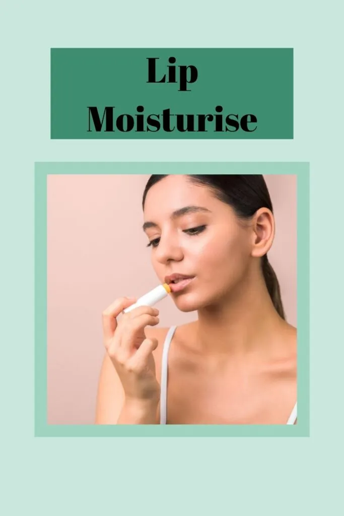 A girl in white top applying lip balm on her lips A girl in white top applying lip balm on her lips - lip care routine