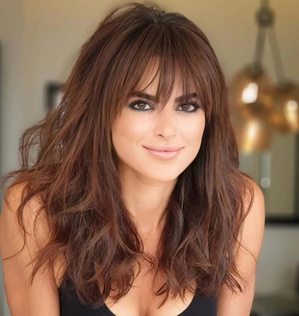 A girl in black deep neck top showing her Long layers with Bangs A girl in black deep neck top showing her Long layers with Bangs - hairstyle for long hair