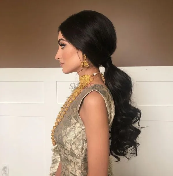 A girl in traditional outfit and jewellery showing the side view of her Low Ponytail A girl in traditional outfit and jewellery showing the side view of her Low Ponytail - hairstyles for long hair