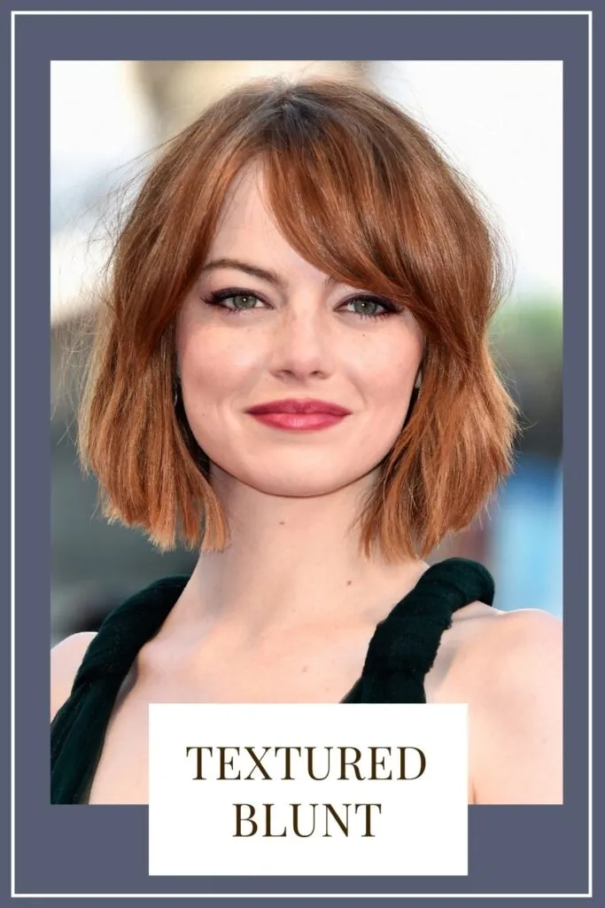 A smiling girl in black top posing for camera and showing her Textured blunt hairstyle - hair color