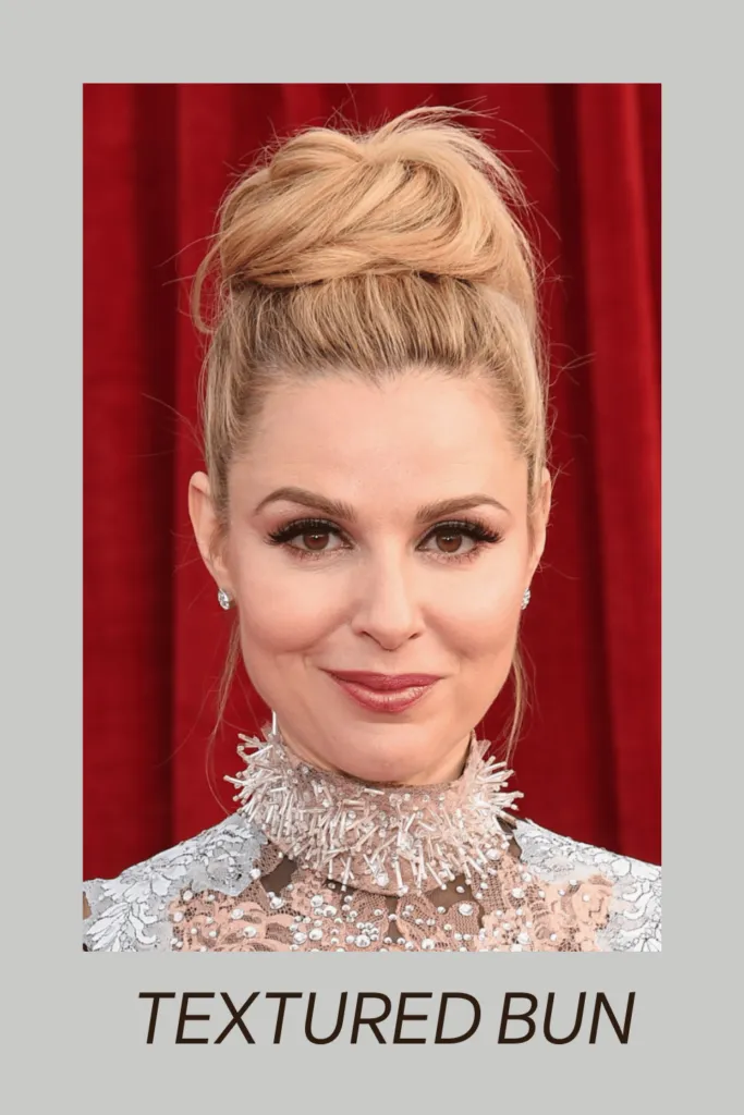 A girl in high neck dress smiling and posing for camera and showing her Textured bun A girl in high neck dress smiling and posing for camera and showing her Textured bun - Haircut for Oval face