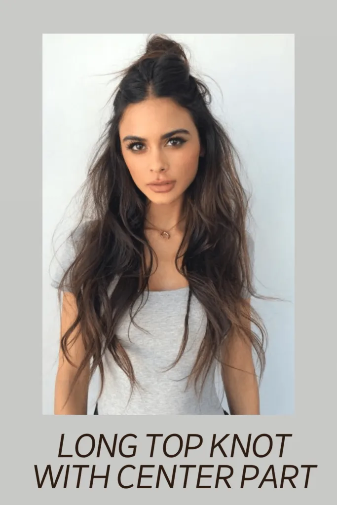 A girl in white top posing for camera and showing her Long top knot with center part hairstyle A girl in white top posing for camera and showing her Long top knot with center part hairstyle - Oval face shape