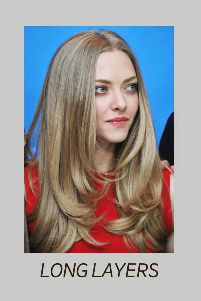 A women in orange dress showing her Long Layers hairstyle A women in orange dress showing her Long Layers hairstyle - Haircut for Oval face
