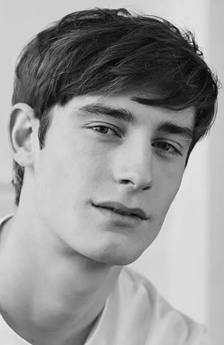 A boy in white t-shirt showing his Side-Swept Fringe hairstyle A boy in white t-shirt showing his Side-Swept Fringe hairstyle - latest hairstyles for boys