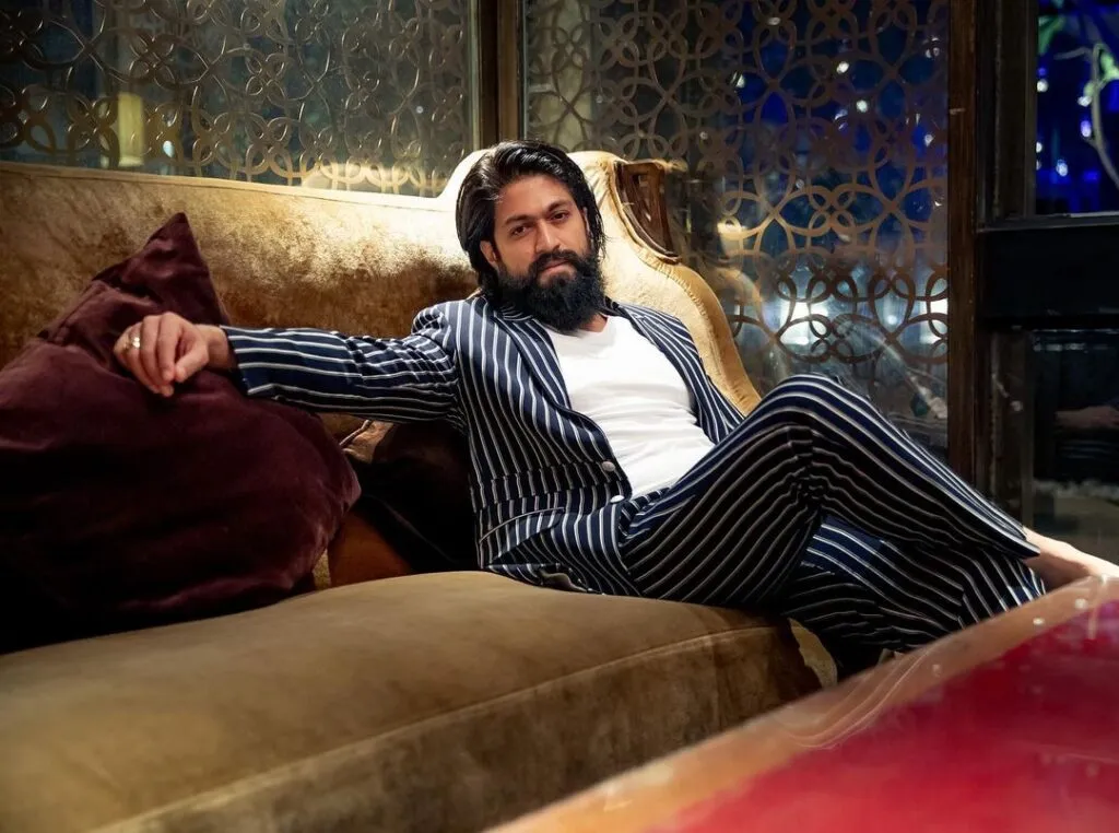 Yash sitting on a sofa in blue lining suit with white t-shirt and posing for camera Yash sitting on a sofa in blue lining suit with white t-shirt and posing for camera - South Indian actors