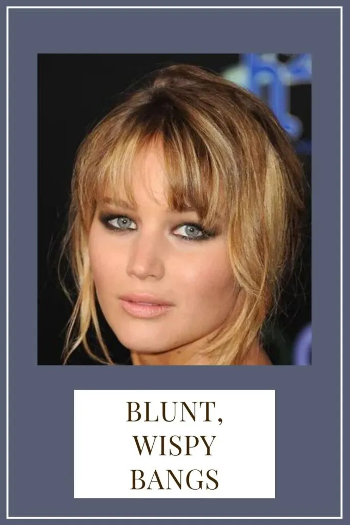 A girl in blonde hair posing for camera and showing her Blunt, wispy bangs hairstyle A girl in blonde hair posing for camera and showing her Blunt, wispy bangs hairstyle - hairstyles for Heart Face 2022