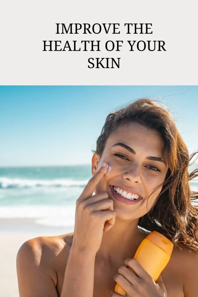 A smiling girl is applying sunscreen on her face A smiling girl is applying sunscreen on her face - Glowing And Protected Skin