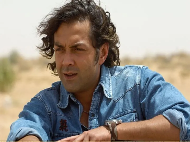 Bobby Deol in blue denim shirt posing for camera and showing his curly bob hairstyle  Bobby Deol in blue denim shirt posing for camera and showing his curly bob hairstyle - actors hairstyle