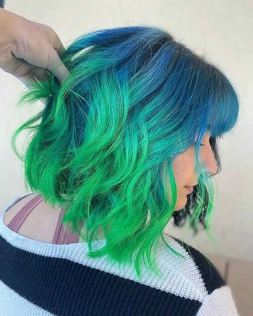 A girl in black and white pullover showing her Blue-Green Hair Color A girl in black and white pullover showing her Blue-Green Hair Color - green hair color ideas for women