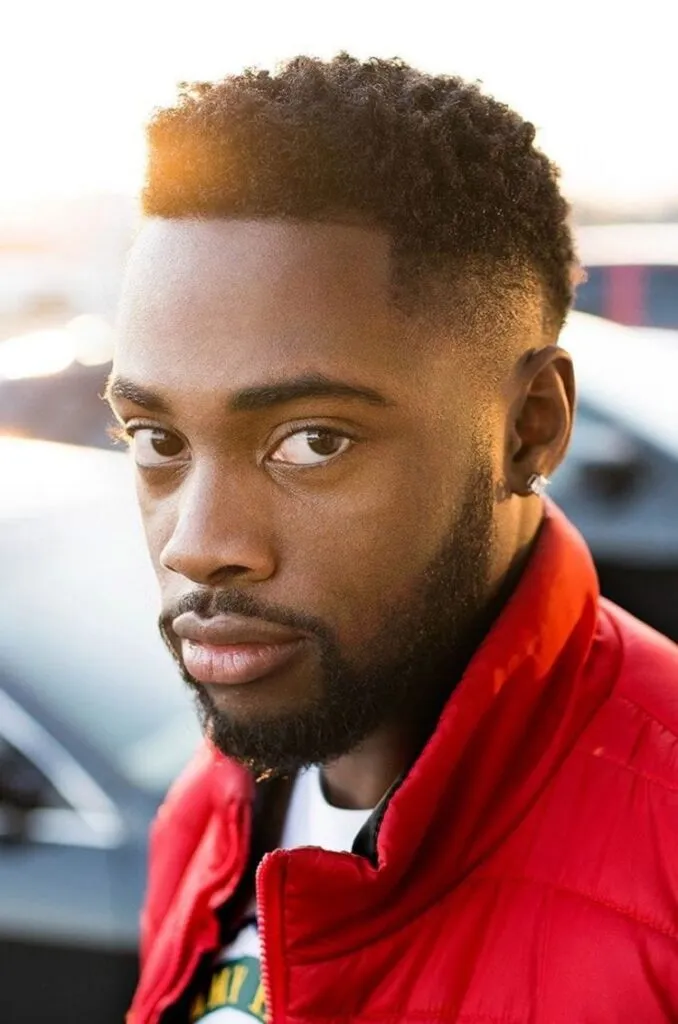 A guy in red jacket with white t-shirt posing for camera and showing his High Volume Top with Temple Faded Sides hairstyles A guy in red jacket with white t-shirt posing for camera and showing his High Volume Top with Temple Faded Sides hairstyles - hairstyles for men 2022