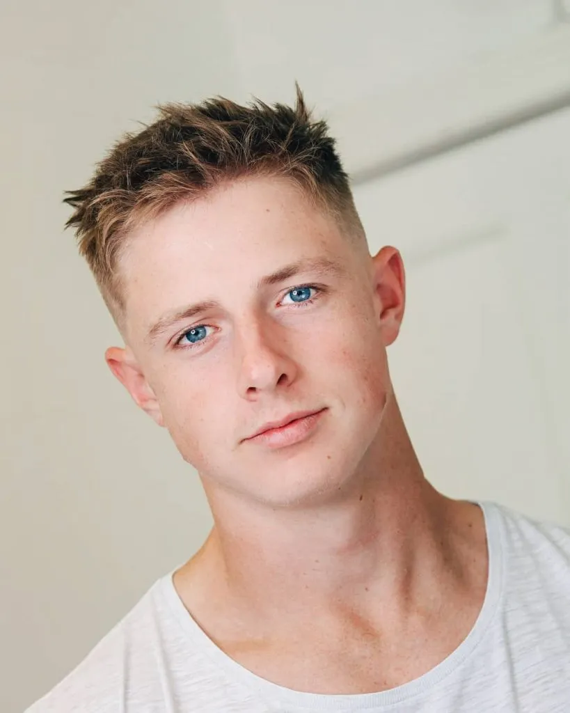 A man in white round neck t-shirt posing for camera and showing off his Shorter Top with Tousled Texture hairstyle A man in white round neck t-shirt posing for camera and showing off his Shorter Top with Tousled Texture hairstyle - hairstyles for men 2022