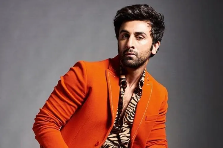 Ranbir Kapoor in orange coat with printed shirt posing for camera Ranbir Kapoor in orange coat with printed shirt posing for camera - latest hairstyles of bollywood actors