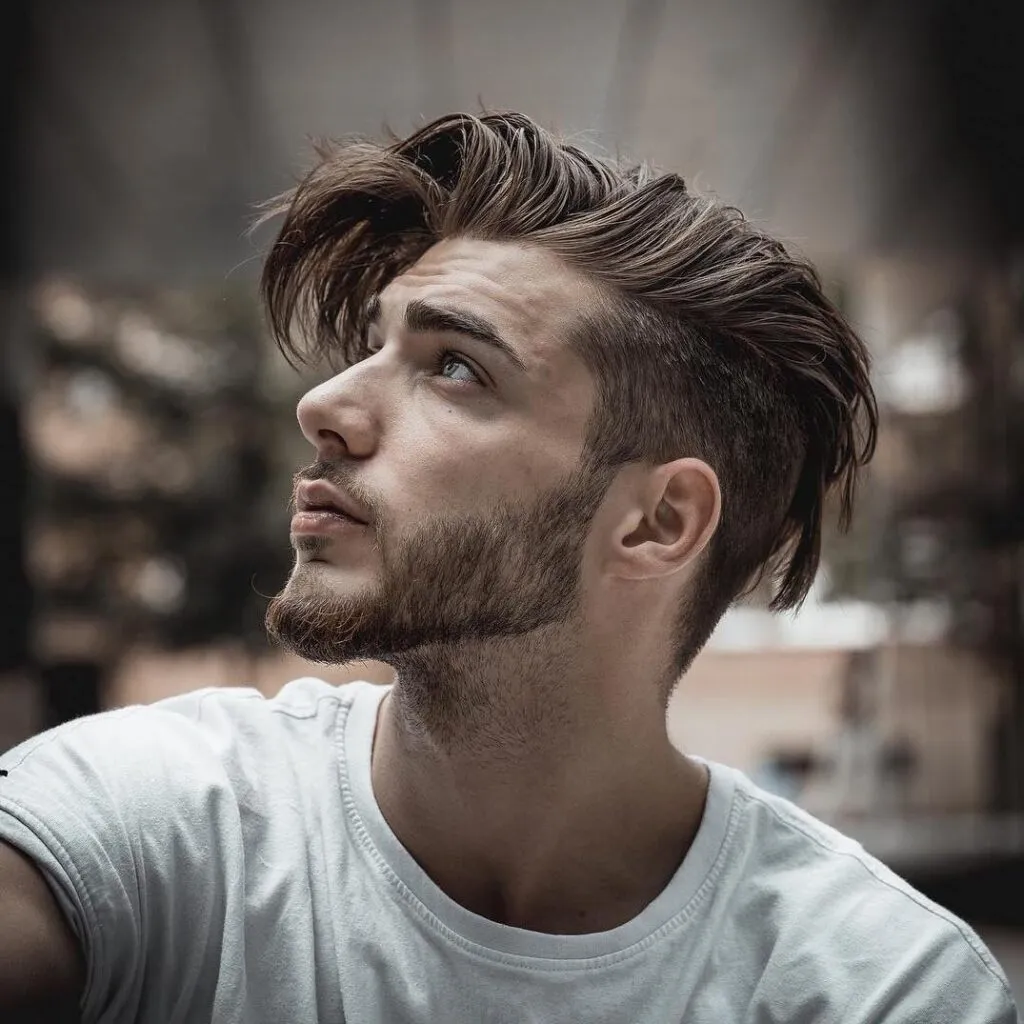 A man in white round neck t-shirt showing the side view of his Undercut With Longer Messy Hair A man in white round neck t-shirt showing the side view of his Undercut With Longer Messy Hair - hairstyle for men