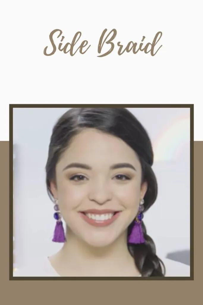 A smiling girl with blue earrings showing her side braid hairstyle A smiling girl with blue earrings showing her side braid hairstyle - trending hairstyle for girls 2022