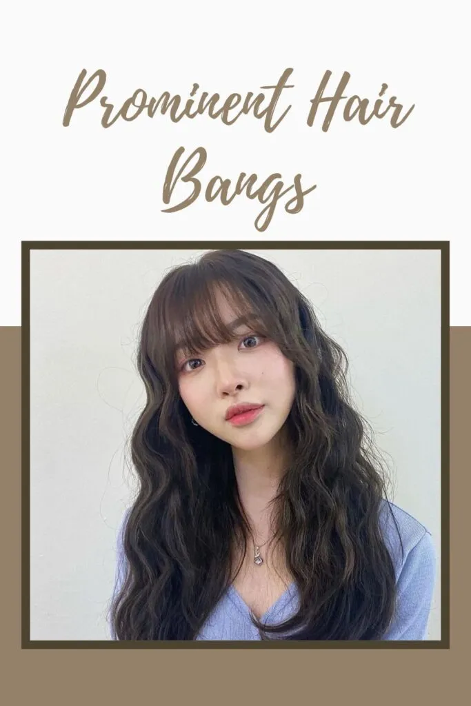 A girl in sky blue top showing her prominent hair with bangs A girl in sky blue top showing her prominent hair with bangs - long hair