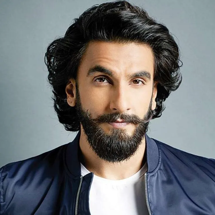 Ranveer Singh posing for camera in bluecoat with blue jacket and white t-shirt Ranveer Singh posing for camera in bluecoat with blue jacket and white t-shirt - Bollywood actors latest hairstyles
