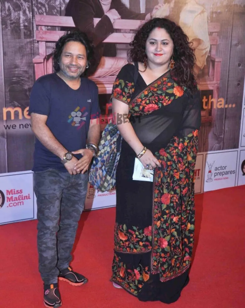 Kailash kher in blue t-shirt with wife in black embroided saree posing for camera Kailash kher in blue t-shirt with wife in black embroided saree posing for camera - famous couple singers India