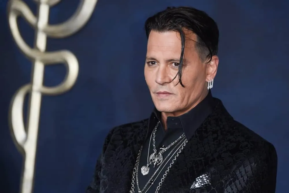 Johnny Depp in black suit with multiple silver neck pieces posing for camera and showing his Tousled Reddish-Brown Hair Johnny Depp in black suit with multiple silver neck pieces posing for camera and showing his Tousled Reddish-Brown Hair - Johnny Depp latest hairstyles