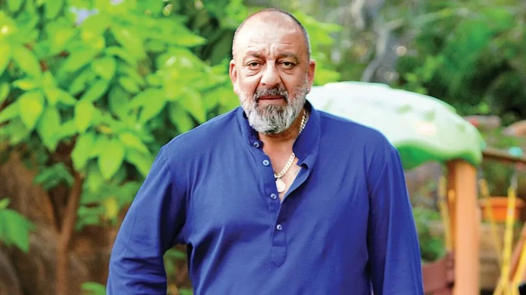 SanJay Dutt in blue shirt posing for camera SanJay Dutt in blue shirt posing for camera - indian actors without makeup
