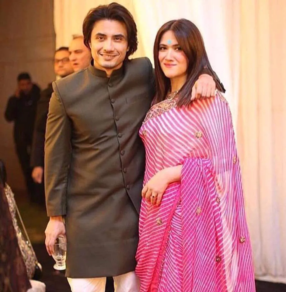 Ali Zafar in grey kurta with his Ayesha Fazli in pink and white lahariya saree Ali Zafar in grey kurta with his Ayesha Fazli in pink and white lahariya saree - Indian singers couples